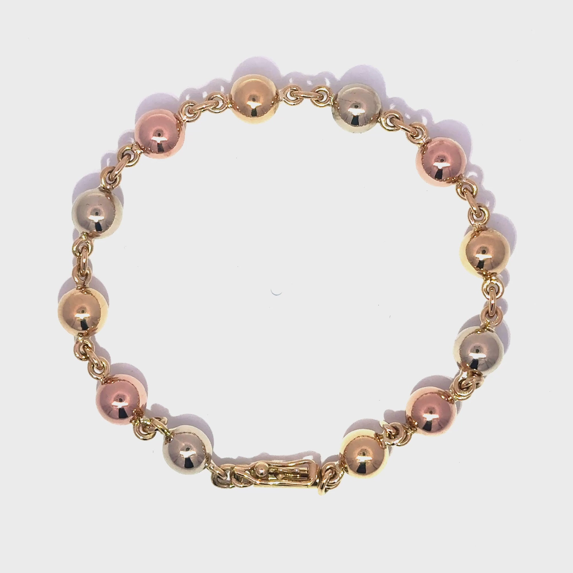 Pulsera de esferas brillantes en tres oros 18k ley 6,5 mm