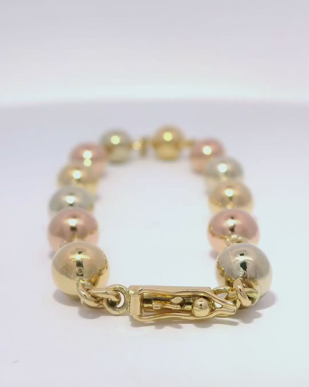 Pulsera de esferas brillantes en tres oros 18k ley 6,5 mm